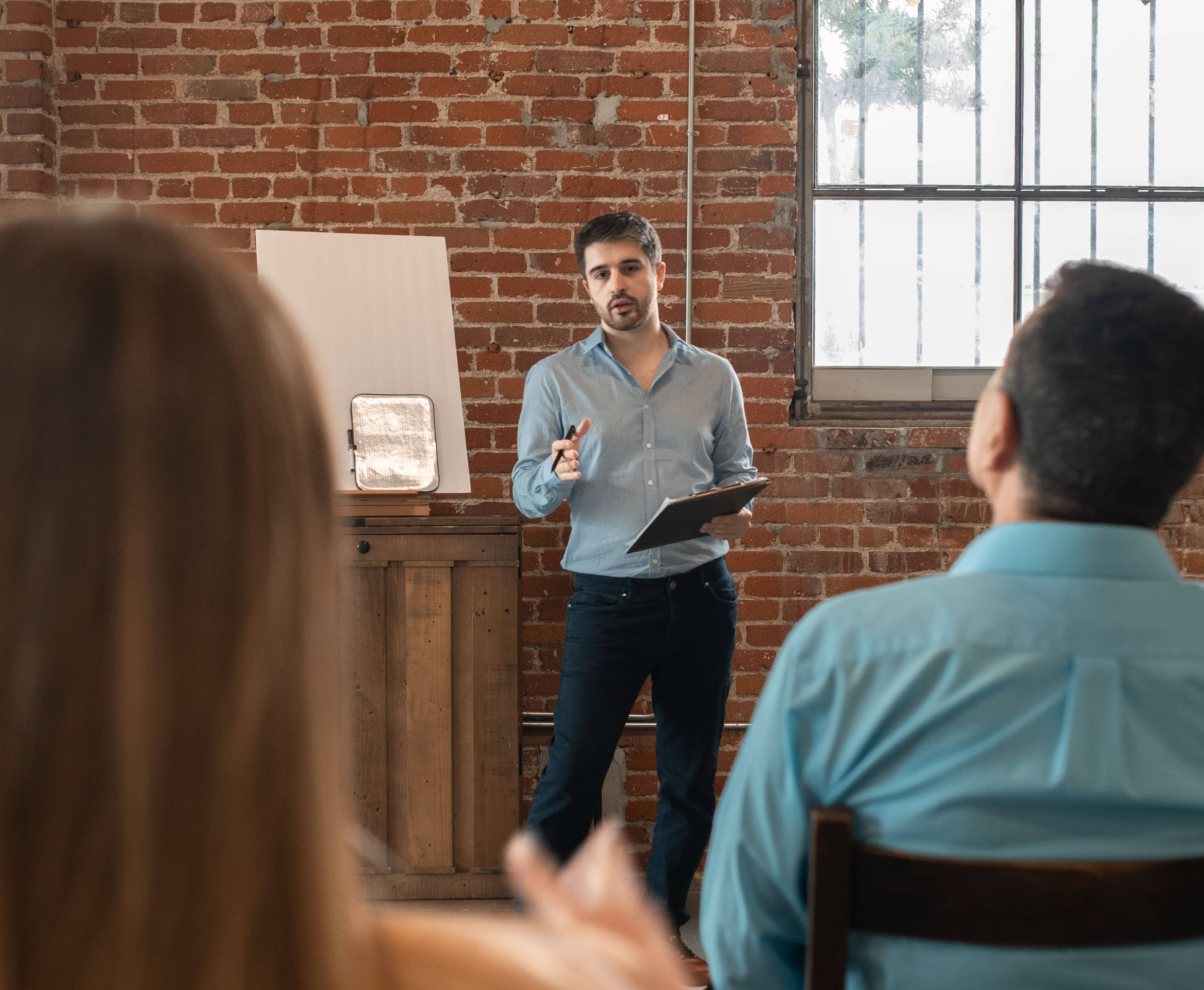 Man standing in front of group of adult learners