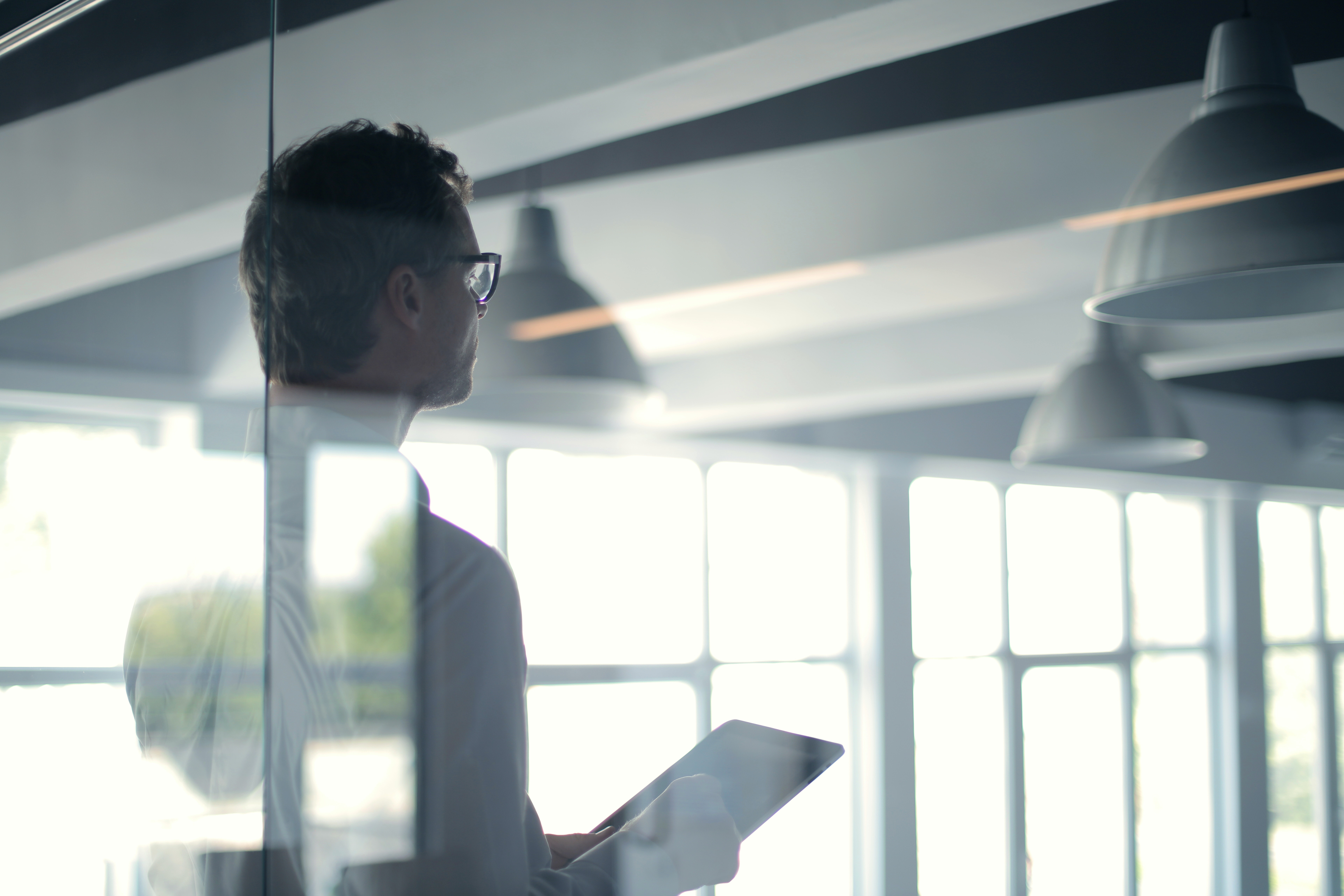 Business executive thoughtfully using tablet