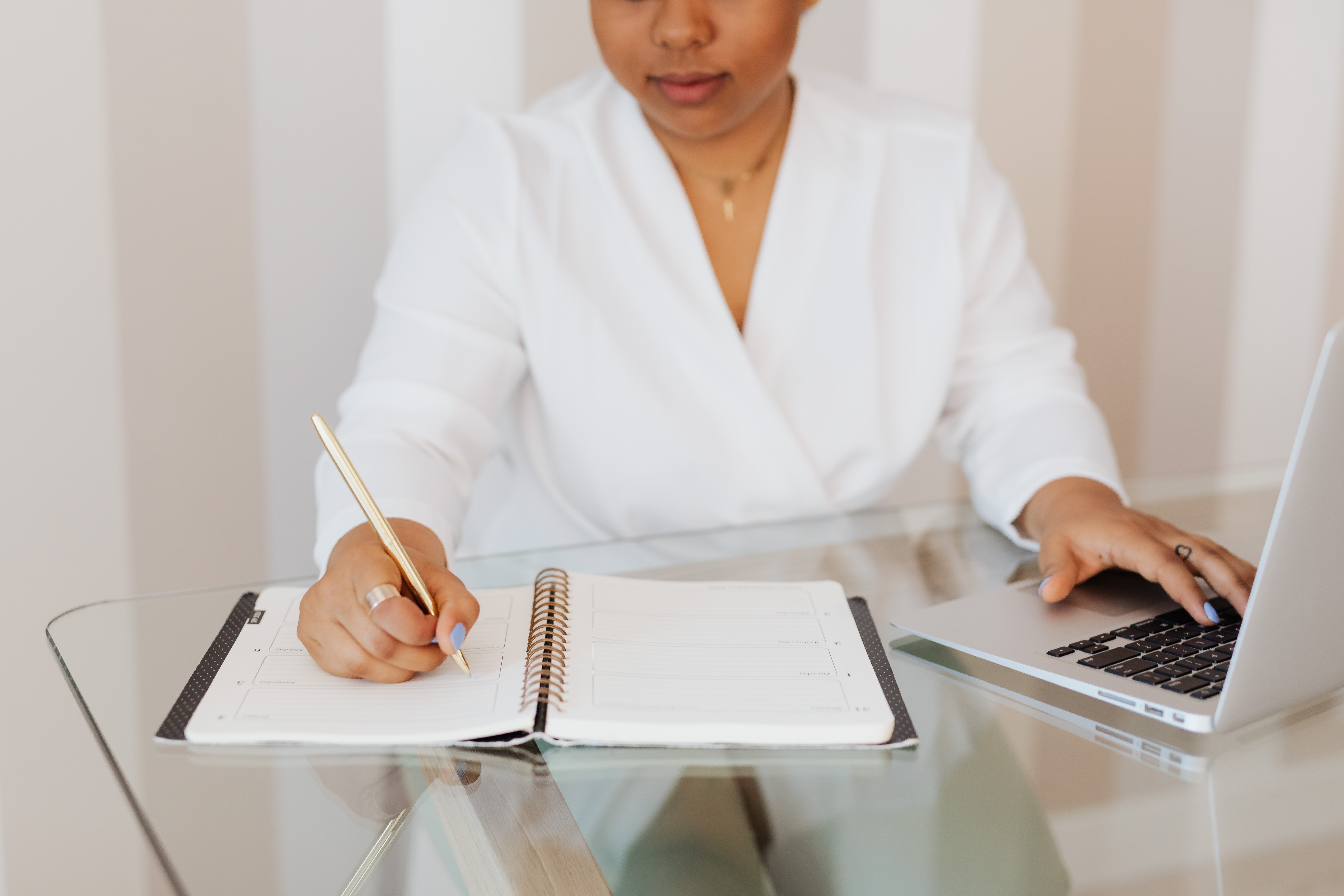 Woman with laptop and notepad