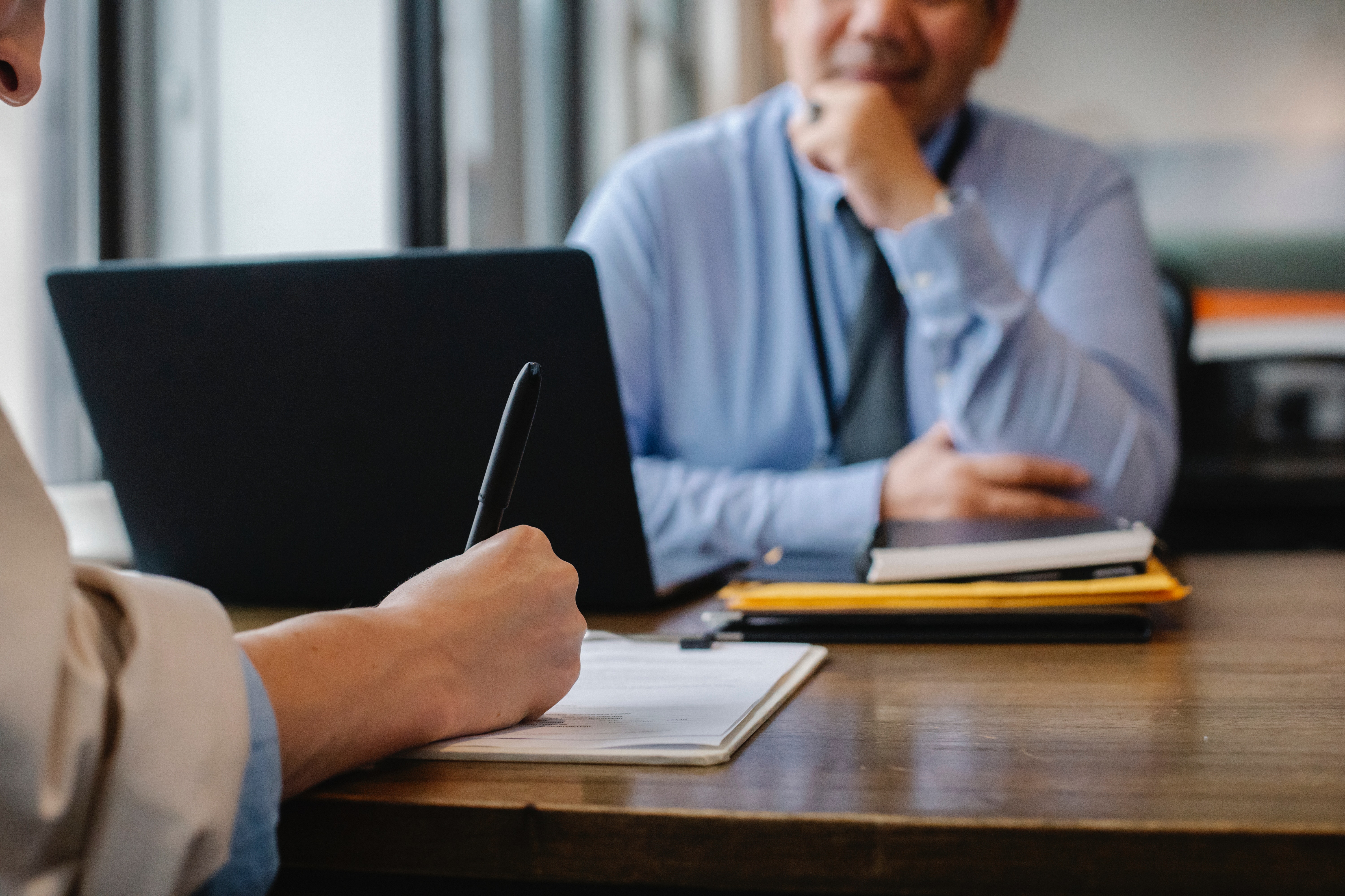 Two people at a desk during a review meeting